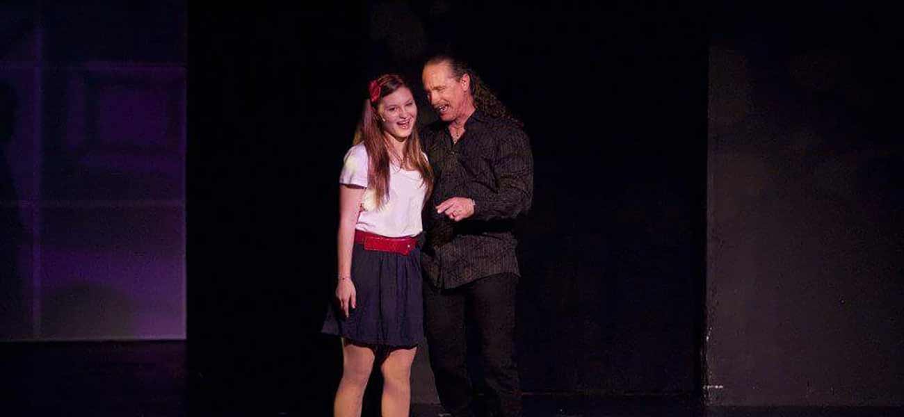 Larry Friedman coaching a young student on stage